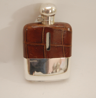 George VI silver spirit flask with leather shoulders