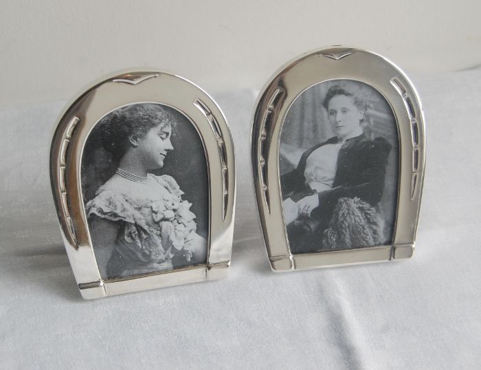 Pair of silver horseshoe-shaped photograph frames